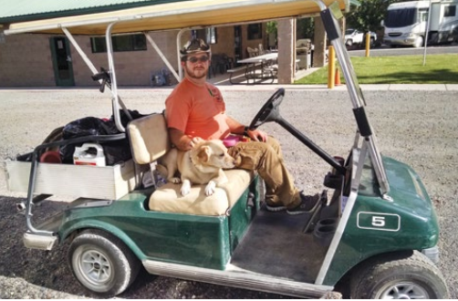 Workamper Levi on a golf cart at his Workamper job