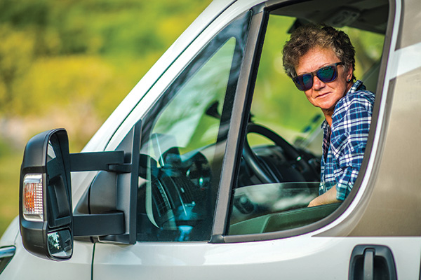 woman driving class b rv looking out window