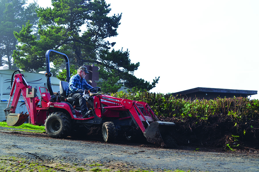 Workamper man on a tractor spreading dirt