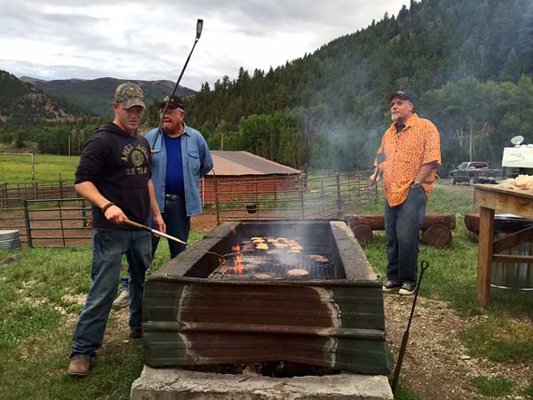 Ranch staff enjoy grilling over an open fire.