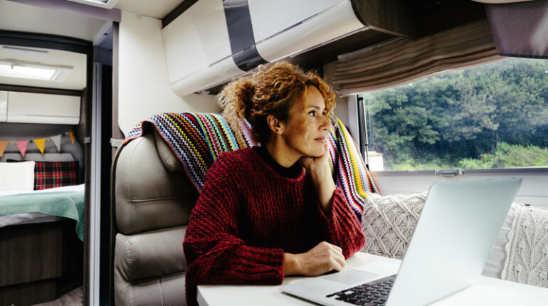 Woman working at laptop in RV